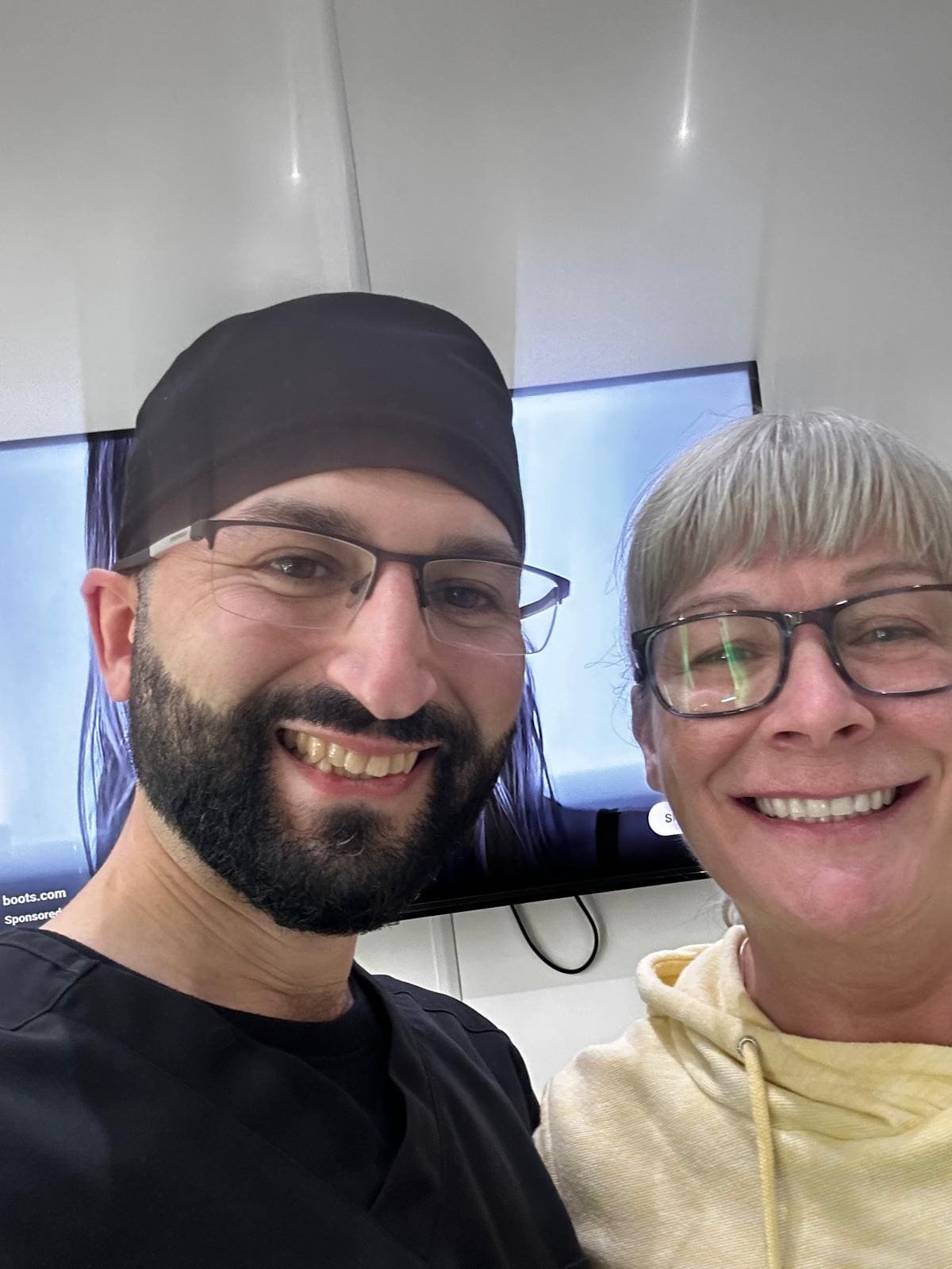 A man and woman smile for the camera.